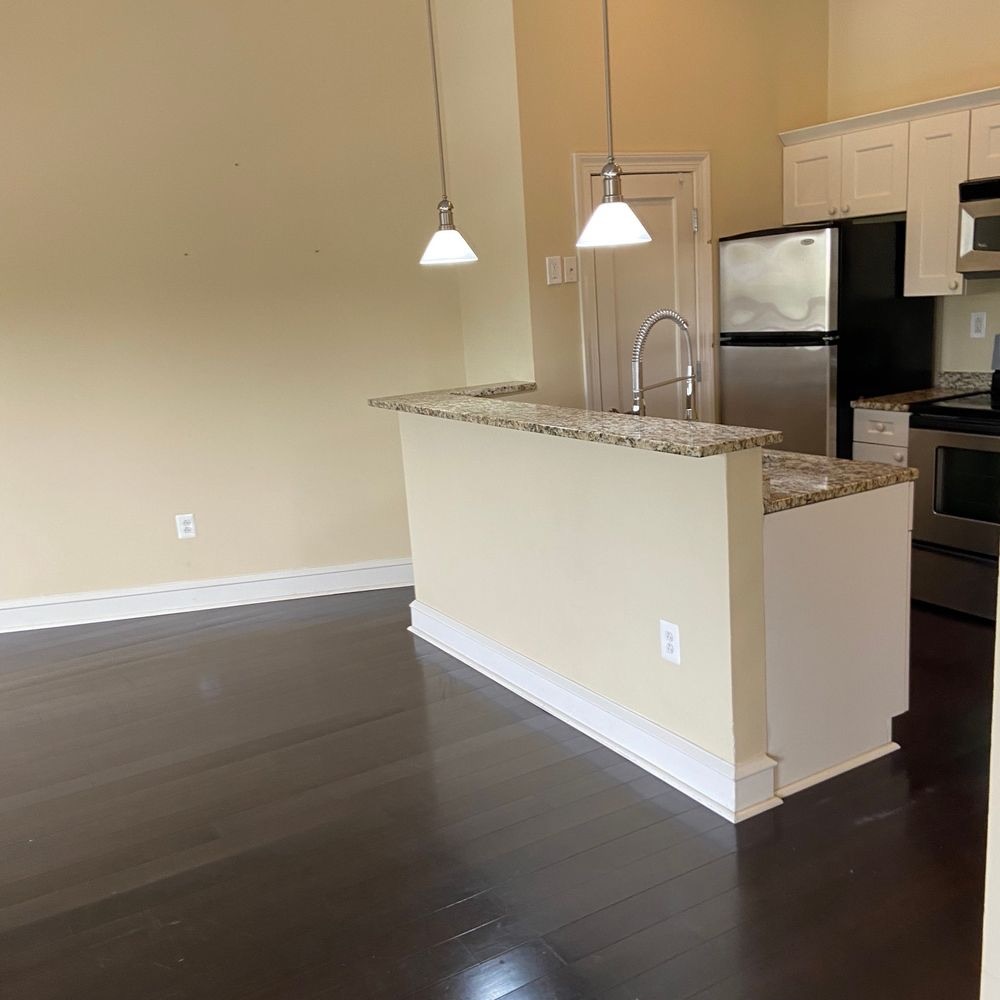 Open kitchen with sparkling clean dark hardwood floors